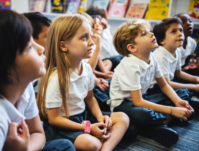 Kindergarten students sitting on the floor